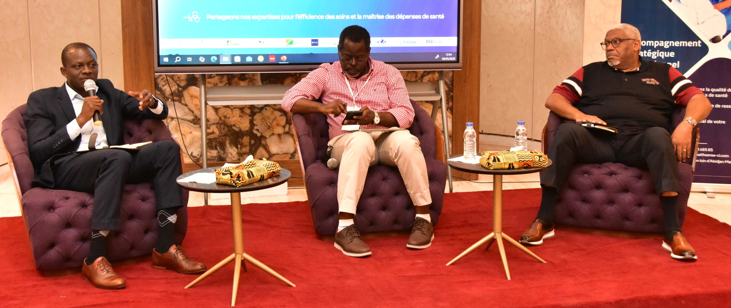 man in black suit pointing in blue screen on wall