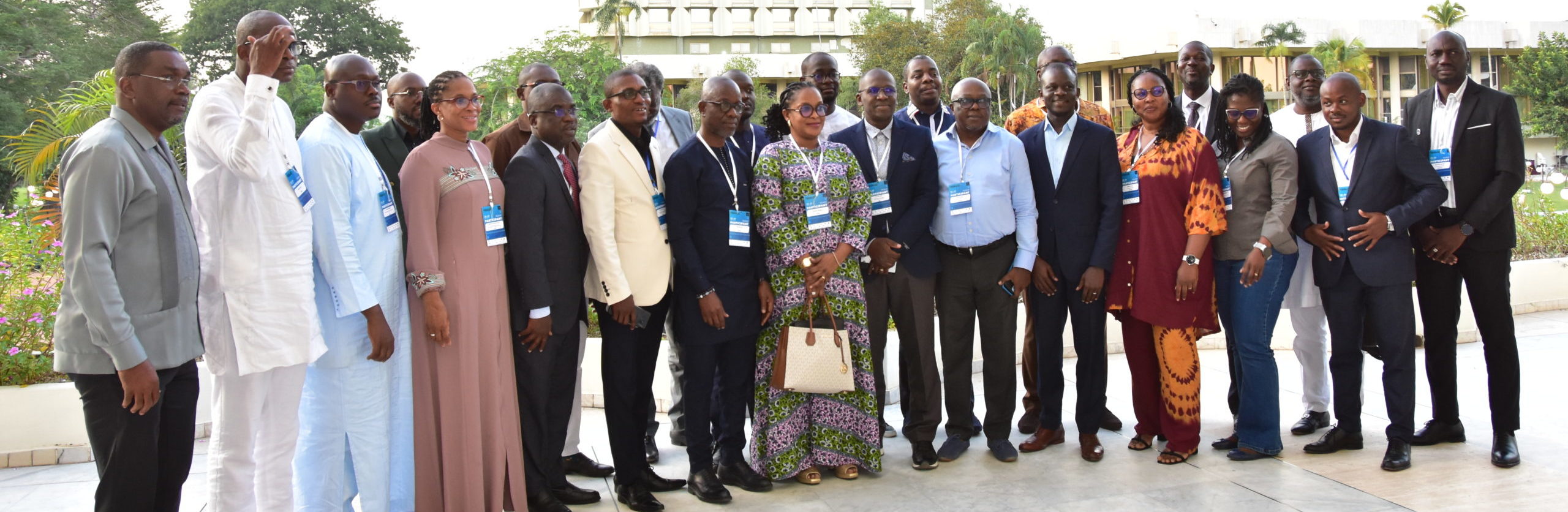 man in black suit pointing in blue screen on wall